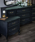 Dixie Belle Paint Midnight Sky Chalk Mineral Paint is the perfect paint for any DIY project! Black chalk Painted Dresser and end table with a Victorian style stencil painted on the side. Staged with gold decorative ball and a candle stick holder with a white candle on top.