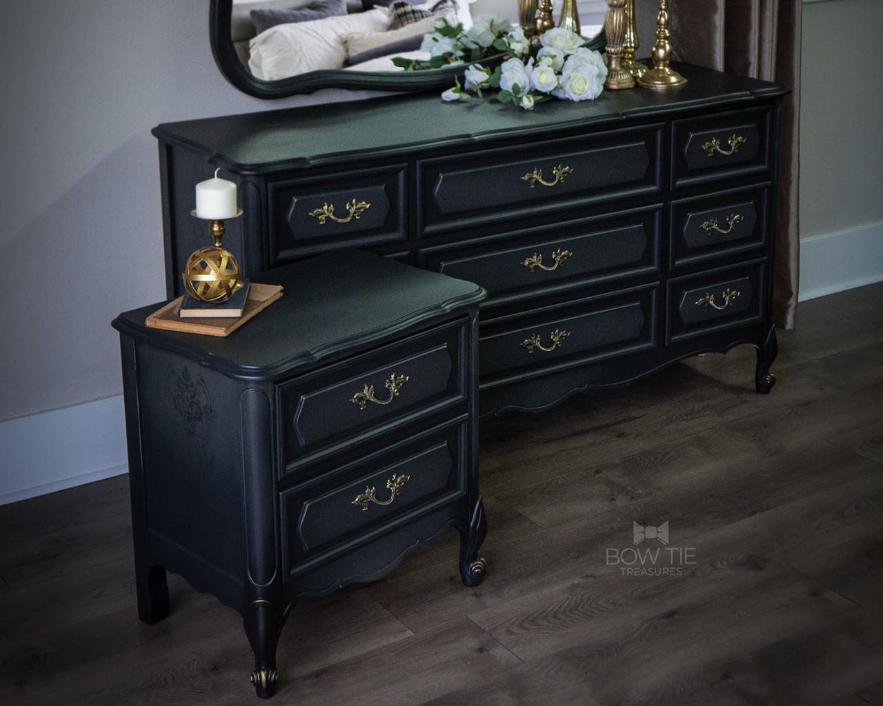 Dixie Belle Paint Midnight Sky Chalk Mineral Paint is the perfect paint for any DIY project! Black chalk Painted Dresser and end table with a Victorian style stencil painted on the side. Staged with gold decorative ball and a candle stick holder with a white candle on top.