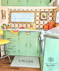 Dixie Belle Paint Mint Julep Chalk Mineral Paint is the perfect paint for any DIY project! retro kitchen with cabinets painted in mint green chalk paint. Staged with retro vintage kitchen décor and a welcome mat.