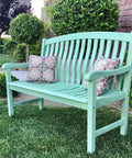 Dixie Belle Paint Mint Julep Chalk Mineral Paint is the perfect paint for any DIY project!
Mint Green chalk painted bench staged outside with colorful pillows.