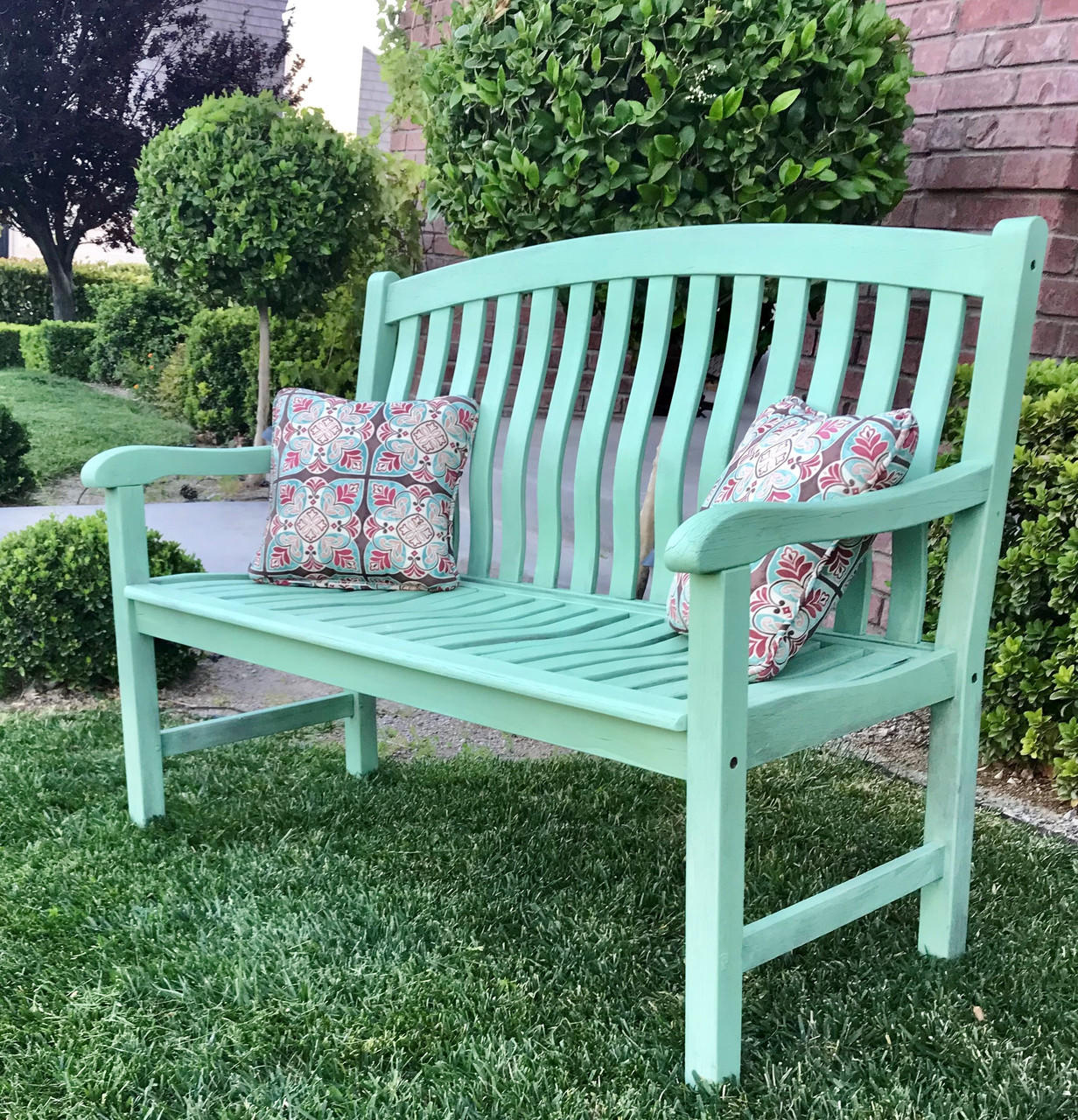 Dixie Belle Paint Mint Julep Chalk Mineral Paint is the perfect paint for any DIY project!
Mint Green chalk painted bench staged outside with colorful pillows.