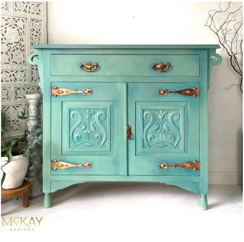 Dixie Belle Paint Mint Julep Chalk Mineral Paint is the perfect paint for any DIY project! Mint chalk painted end table with gold hardware. Staged next to a potted plant.