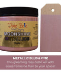 Rozay Moonshine metallic is the perfect paint to add shimmer and shine to your chalk painted furniture. Metallic blush pink, this gleaming rosy color will add some feminine flair to your space. 16 oz. Jar of Rozay Moonshine Metallic next to a sample on wood.