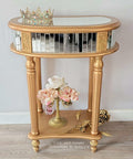 Metallic Gold Moonshine metallic is the perfect paint to add shimmer and shine to your chalk painted furniture. Gold moonshine metallic end table with mirrors on the side and on top. Staged with a crown , a gold vase and pink flowers.