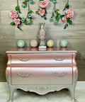 Silver Bullet Moonshine metallic is the perfect paint to add shimmer and shine to your chalk painted furniture. Pink and purple ombre moonshine metallic dresser. Staged with flowers, colored balls and a decorative acorn statue.