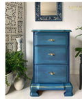 Metallic Aqua Blue Moonshine metallic is the perfect paint to add shimmer and shine to your chalk painted furniture. Blue Metallic chalk mineral painted end table with gold paint on the bottom. Staged next to floral plants.
