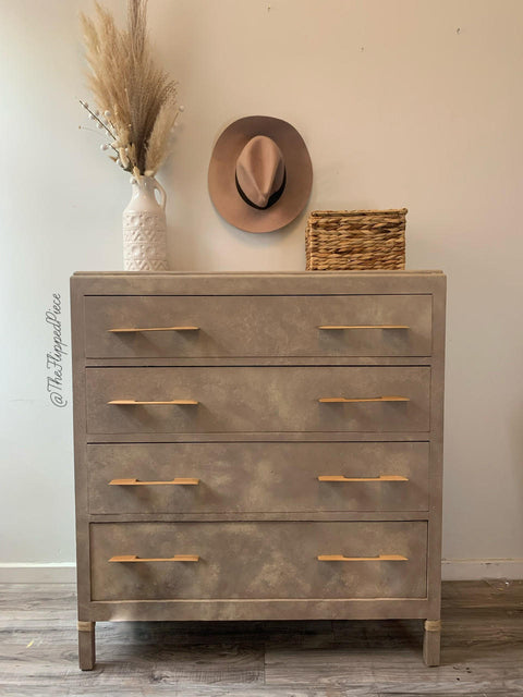 Dixie Belle Paint Mud Puddle Chalk Mineral Paint is the perfect paint for any DIY project!
Vintage style dresser painted in Dixie Belle Paint Mud Puddle Chalk Mineral Paint. Staged with a hat, wicker basket, and a white vase with faux wheat plants.