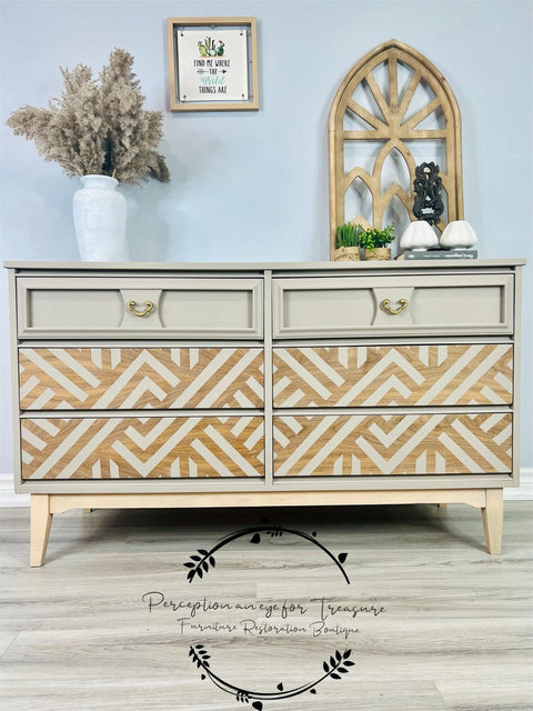 Dixie Belle Paint Mud Puddle Chalk Mineral Paint is the perfect paint for any DIY project! Dresser painted in Dixie Belle Paint Mud Puddle Chalk Mineral Paint with wood grain drawers and a line work painted on them. Staged with wooded arch, and some plants.