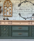 Dixie Belle Paint Mud Puddle Chalk Mineral Paint is the perfect paint for any DIY project! Dresser with bottom half painted green and top half painted in Dixie Belle Paint Mud Puddle Chalk Mineral Paint. Staged with bird figures and a plant.