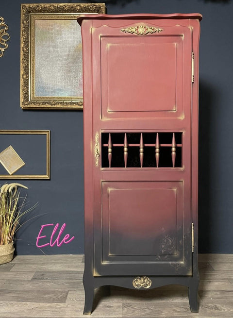 Dixie Belle Paint Muscadine Wine Chalk Mineral Paint is the perfect paint for any DIY project! Tall armoire painted in a dark red chalk paint blended with black, there is gold painted on to highlight accents.