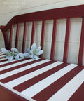 Dixie Belle Paint Muscadine Wine Chalk Mineral Paint is the perfect paint for any DIY project! Bench painted with dark red Chalk Mineral Paint with white stripes on the seat.