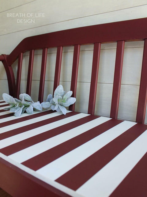 Dixie Belle Paint Muscadine Wine Chalk Mineral Paint is the perfect paint for any DIY project! Bench painted with dark red Chalk Mineral Paint with white stripes on the seat.