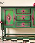 Dixie Belle Paint Palmetto Chalk Mineral Paint is the perfect paint for any DIY project! Green chalk painted foyer hutch with pink blended into the corners. Staged with a glass vase and pink flowers.