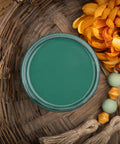 Dixie Belle Paint Palmetto Chalk Mineral Paint is the perfect paint for any DIY project! Top view of green open paint can with wood beads and a yellow flower next to it.