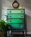 Dixie Belle Paint Palmetto Chalk Mineral Paint is the perfect paint for any DIY project! Green chalk painted Ombre dresser. Staged with a potted plant, candle sticks and a gold mirror.