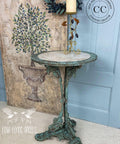 Dixie Belle Paint Patina Paint. Metal table Painted and sprayed with Patina to look rusty. Staged in front of a Blue door.