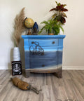 Dixie Belle Paint Patina Paint. light blue and dark blue Chalk painted end table painted with patina paint on the bottom to look rusty. Staged with nautical décor and plants.