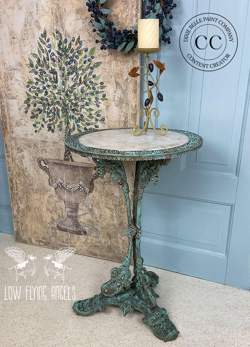 Dixie Belle Paint Patina Spray. Metal table Painted and sprayed with Patina to look rusty. Staged in front of a Blue door.
