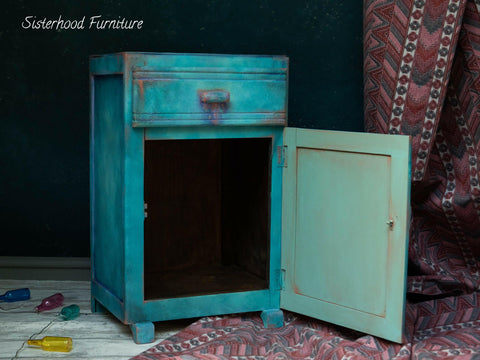 Dixie Belle Paint Peacock Chalk Mineral Paint is the perfect paint for any DIY project! Blue chalk painted end table cabinet with red chalk paint blended to make it look distressed.