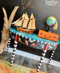 Dixie Belle Paint Peacock Chalk Mineral Paint is the perfect paint for any DIY project! end table painted black with black and white stripe legs, blue chalk paint on the top and koi rub on transfers.