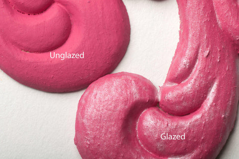 Dixie Belle Paint Pearlescent Glaze. Two pieces of pink chalk painted decorative appliques, one without glaze and one with glaze applied, with a white background.