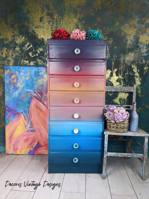 Dixie Belle Paint Pearlescent Glaze. Colorful rainbow chalk painted tall skinny dresser with Pearlescent Glaze painted on. Staged with colorful flowers.