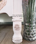 Dixie Belle Paint Pink Champagne Chalk Mineral Paint is the perfect paint for any DIY project! Up close of a leg on a dresser with a rose applique that has been painted in a light pink chalk paint.