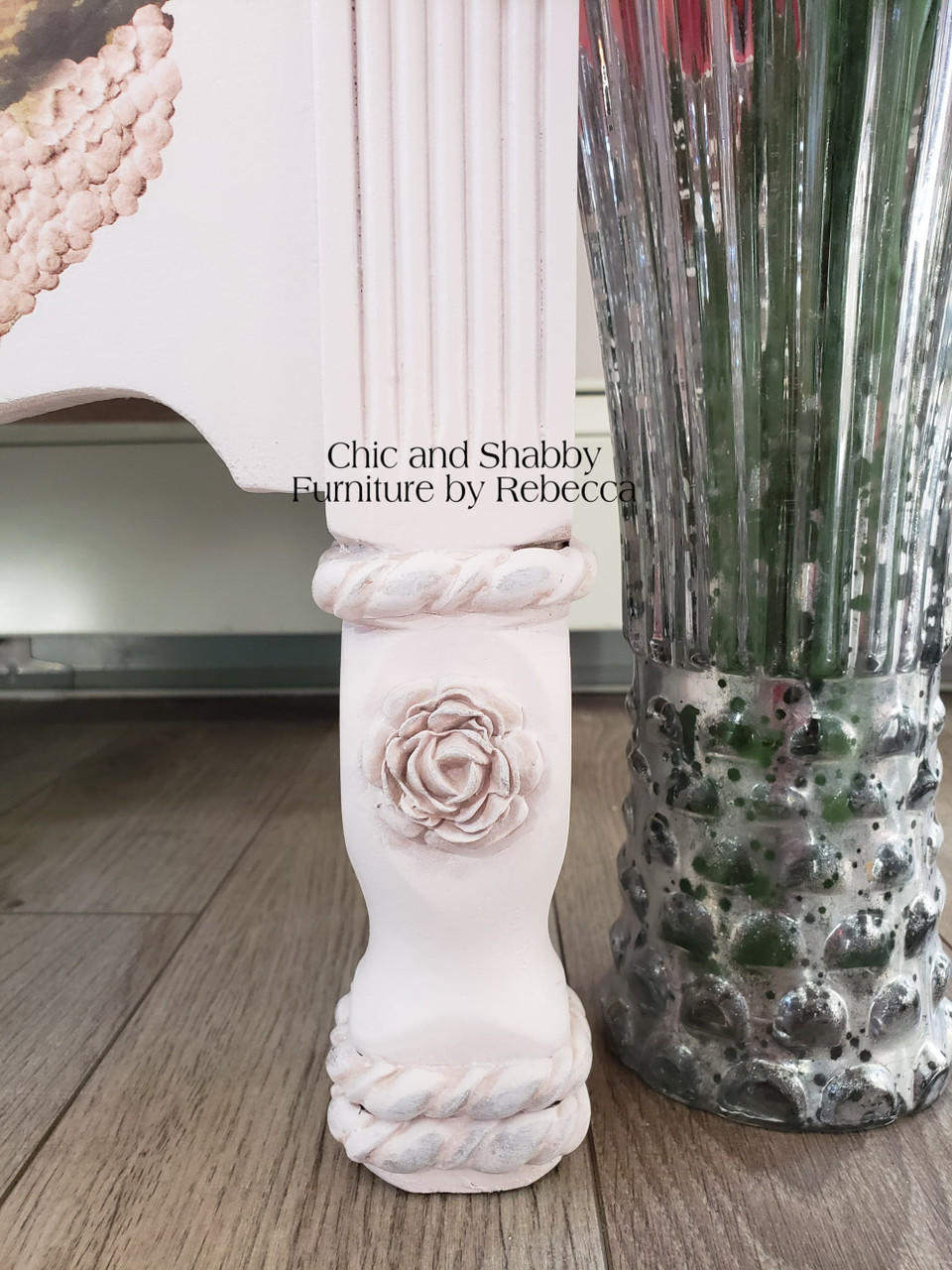 Dixie Belle Paint Pink Champagne Chalk Mineral Paint is the perfect paint for any DIY project! Up close of a leg on a dresser with a rose applique that has been painted in a light pink chalk paint.