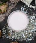 Dixie Belle Paint Pink Champagne Chalk Mineral Paint is the perfect paint for any DIY project! Open top view of a light pink chalk mineral paint staged with roses and glass pieces.