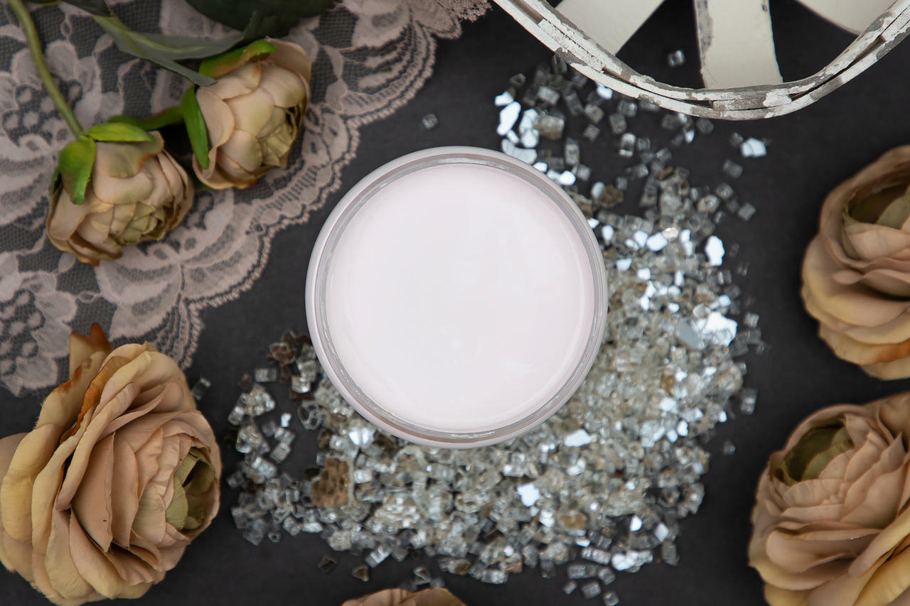 Dixie Belle Paint Pink Champagne Chalk Mineral Paint is the perfect paint for any DIY project! Open top view of a light pink chalk mineral paint staged with roses and glass pieces.