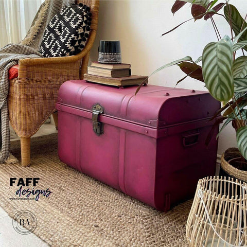 Dixie Belle Paint Plum Crazy Chalk Mineral Paint is the perfect paint for any DIY project! Maroon chalk painted trunk with bronze hard ware and black blended to give it an old look. Staged with book and a black flower pot.