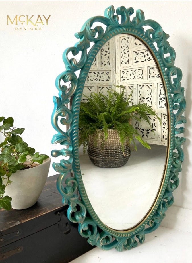 Dixie Belle Paint Pure Ocean Chalk Mineral Paint is the perfect paint for any DIY project! Blue chalk painted mirror with gold on the edges. Staged with potted plants.