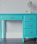 Dixie Belle Paint Pure Ocean Chalk Mineral Paint is the perfect paint for any DIY project! Blue chalk painted desk with silver hard ware. Staged with a crystal lamp.