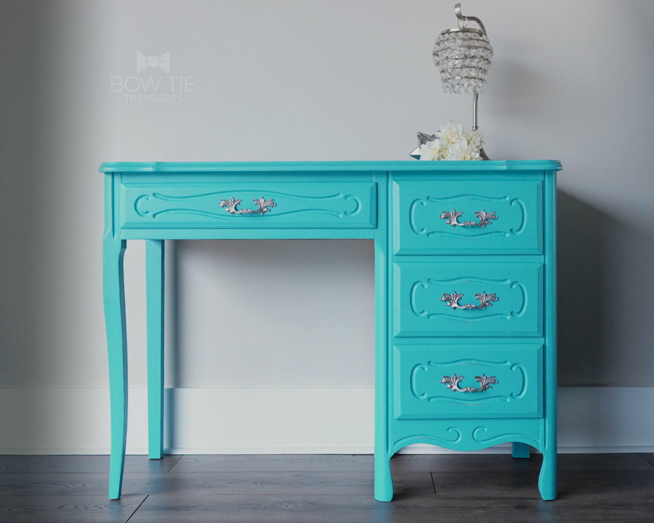 Dixie Belle Paint Pure Ocean Chalk Mineral Paint is the perfect paint for any DIY project! Blue chalk painted desk with silver hard ware. Staged with a crystal lamp.