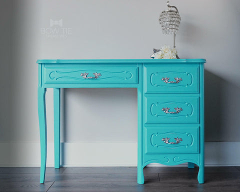 Dixie Belle Paint Pure Ocean Chalk Mineral Paint is the perfect paint for any DIY project! Blue chalk painted desk with silver hard ware. Staged with a crystal lamp.