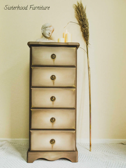 Dixie Belle Paint Putty Chalk Mineral Paint is the perfect paint for any DIY project! A simple 5 drawer bedside table in a muted taupe colored with various brown tones to create dimension throughout the sides of the piece and dripping effect of paint under the hardware staged with 3 candles of different lengths,  a singular pampas grass, and a bust.