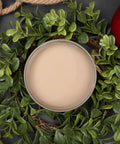 Dixie Belle Paint Putty Chalk Mineral Paint is the perfect paint for any DIY project! Top view of an open jar of paint staged with greenery, rope and an apple surrounding the jar of paint.