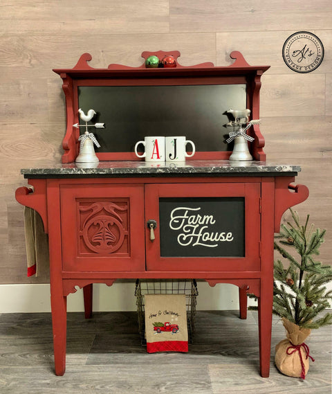 Dixie Belle Paint Rustic Red Chalk Mineral Paint is the perfect paint for any DIY project! A farmhouse bakery table featuring the rustic red and has a cupboard on the bottom. The bakery table is staged with various kitchen decor.