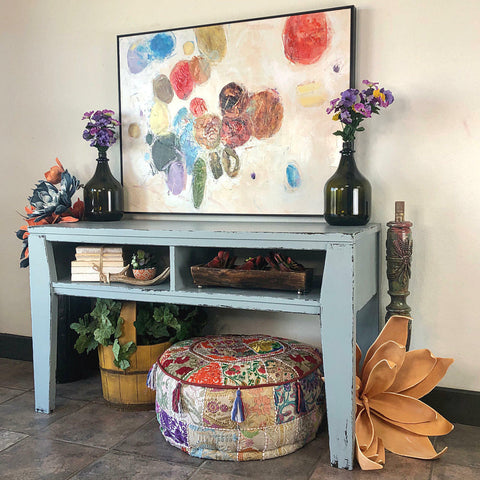 Dixie Belle Paint Savannah Mist Chalk Mineral Paint is the perfect paint for any DIY project! A desk that is painted in this light blue color, savannah mist. The desk is staged with various different home decor items.