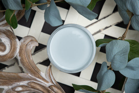 Dixie Belle Paint Savannah Mist Chalk Mineral Paint is the perfect paint for any DIY project! An image of the open jar of paint, savannah mist, that is staged with various staging props.