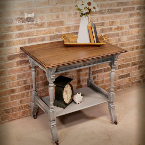 Dixie Belle Paint Sawmill Gravy Chalk Mineral Paint is the perfect paint for any DIY project! A small side table that is painted in sawmill gravy and is distressed. The top of the table is natural wood with a golden brown tone.