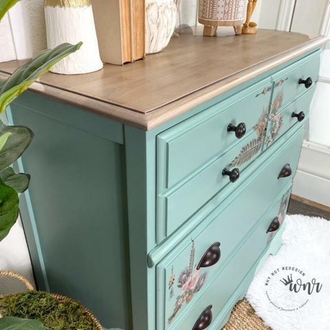 Dixie Belle Paint Sea Glass Chalk Mineral Paint is the perfect paint for any DIY project! A dresser painted in sea glass with a natural wooden top and a peacock transfer on the front.