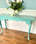 Dixie Belle Paint Sea Glass Chalk Mineral Paint is the perfect paint for any DIY project! A table that is painted in sea glass with a white stencil on top.
