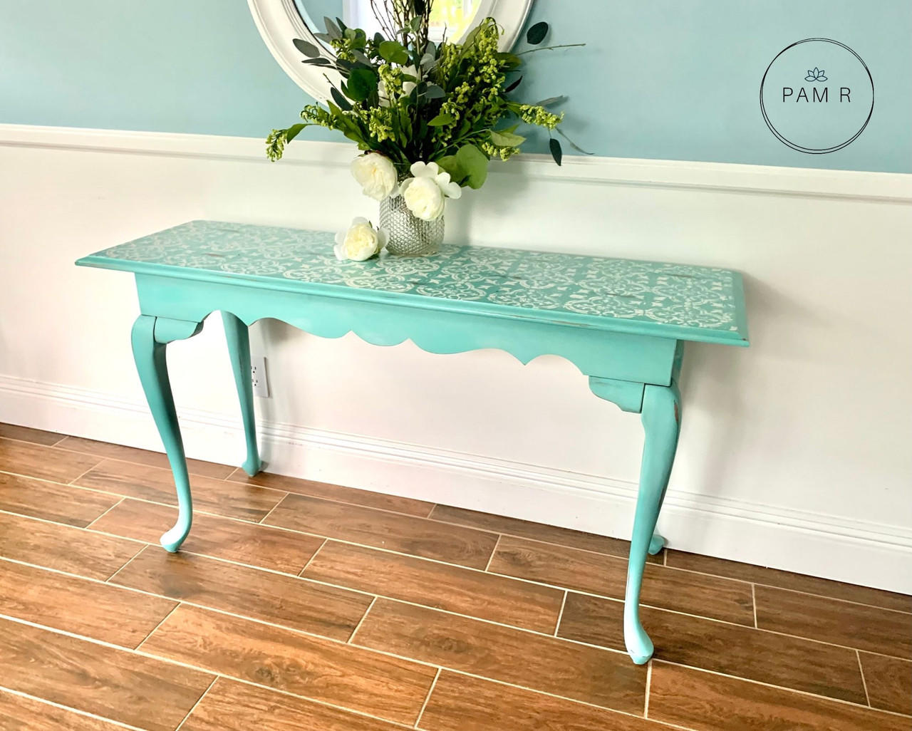 Dixie Belle Paint Sea Glass Chalk Mineral Paint is the perfect paint for any DIY project! A table that is painted in sea glass with a white stencil on top.
