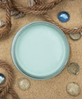 Dixie Belle Paint Sea Glass Chalk Mineral Paint is the perfect paint for any DIY project! An image of an opened jar of paint in the color sea glass.