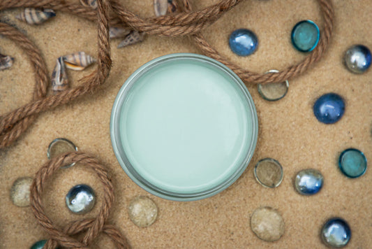 Dixie Belle Paint Sea Glass Chalk Mineral Paint is the perfect paint for any DIY project! An image of an opened jar of paint in the color sea glass.