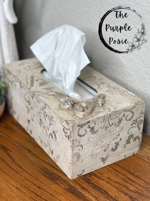 Dixie Belle Paint Sea Spray creates a chippy, textured & weathered look when mixed with your favorite Dixie Belle color. A beige painted tissue box with a stencil in a darker brown with sea spray added to show texture.