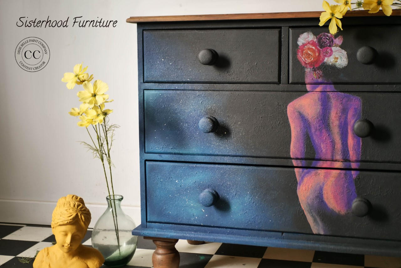 Dixie Belle Paint Sea Spray creates a chippy, textured & weathered look when mixed with your favorite Dixie Belle color. A black dresser with a hand-painted lady on the front with a blended cloud of blue. These colors on this dresser is accompanied by sea spray to give it texture.