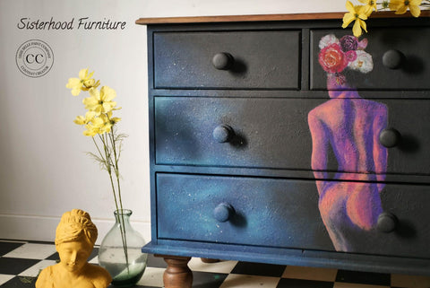 Dixie Belle Paint Sea Spray creates a chippy, textured & weathered look when mixed with your favorite Dixie Belle color. A black dresser with a hand-painted lady on the front with a blended cloud of blue. These colors on this dresser is accompanied by sea spray to give it texture.