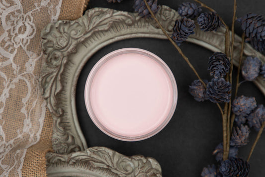 Dixie Belle Paint Soft Pink Chalk Mineral Paint is the perfect paint for any DIY project! A staged product image with an open jar of our soft pink chalk mineral paint.
